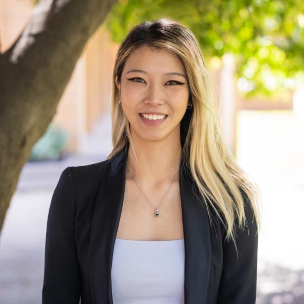 Professional photo of Emily, smiling at the camera.