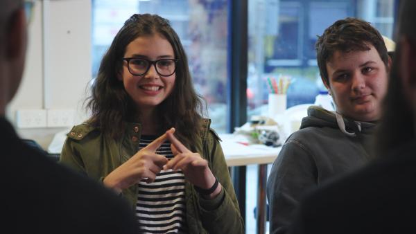 A young person using Auslan