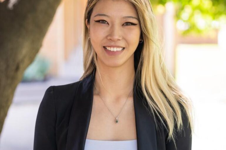 Professional photo of Emily, smiling at the camera.